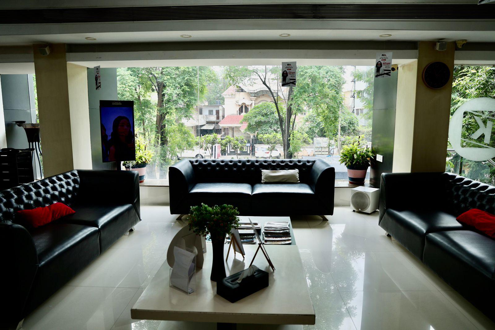 Black leather lounge sofas at Kutz The Salon